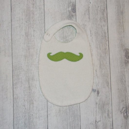 Bavoir moustache imprimé pois blancs sur fond vert